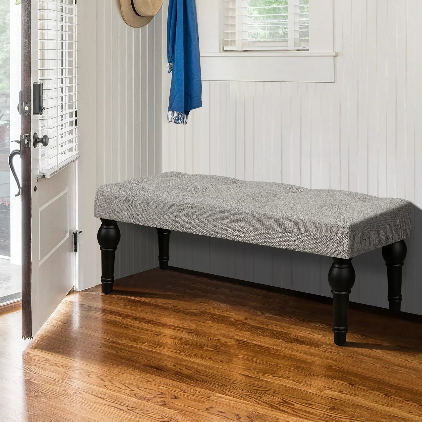 Soft grey 42-inch Ottoman bench with linen fabric, button-tufted seat, Roman column feet, and skid foot pads.